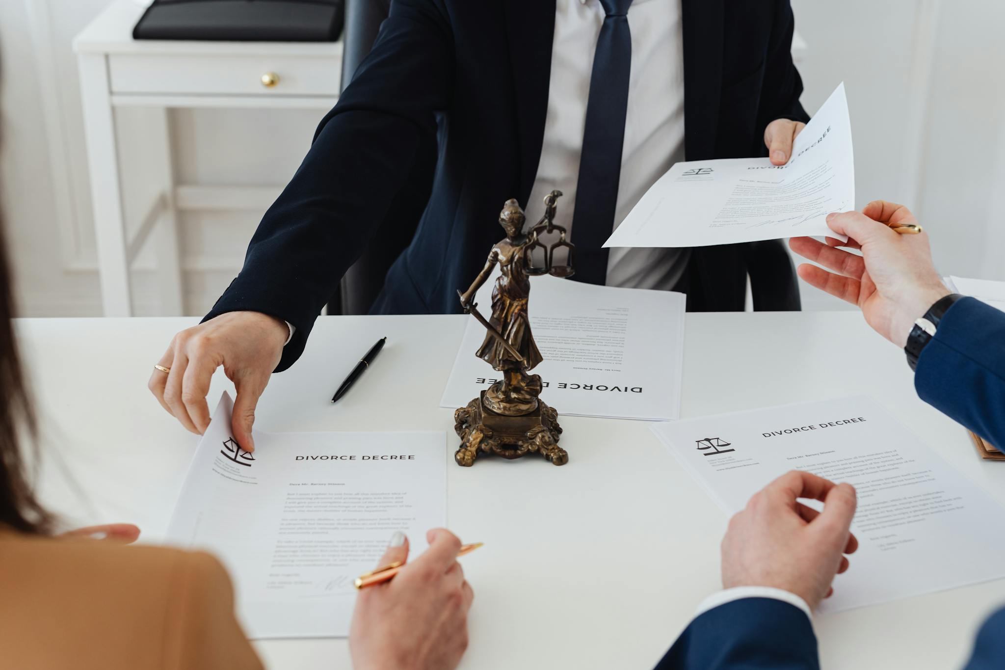 three adults discussing divorce documents in a